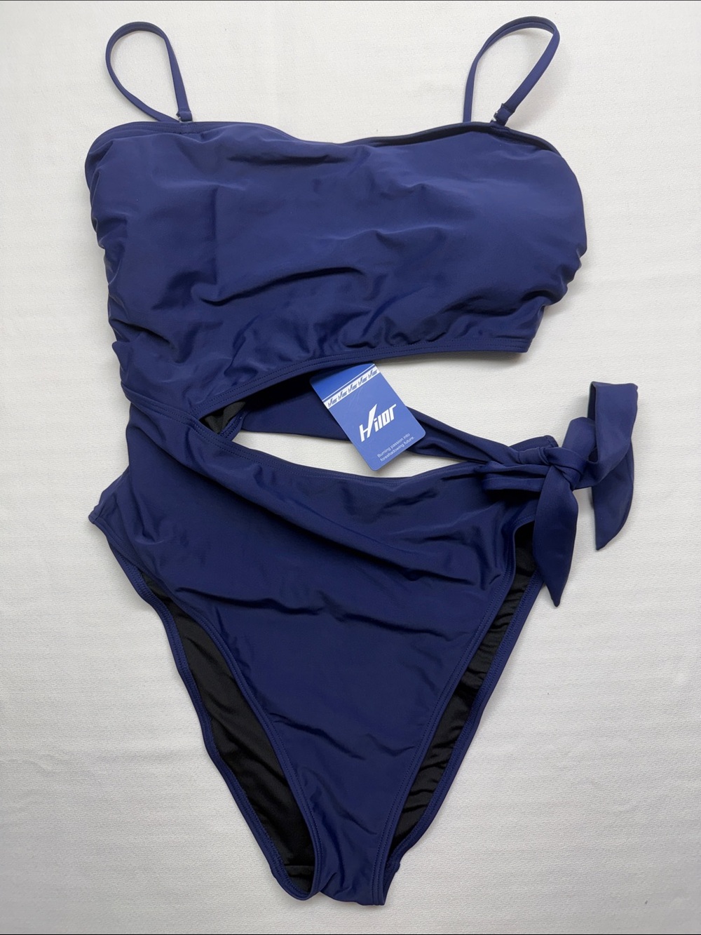 Hilor one-piece swimsuit features a solid navy blue a stylish side tie detail